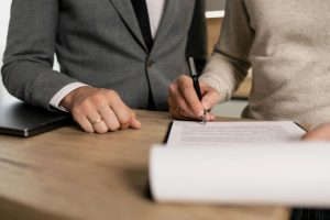 a photo of a man and woman's hands reading a document